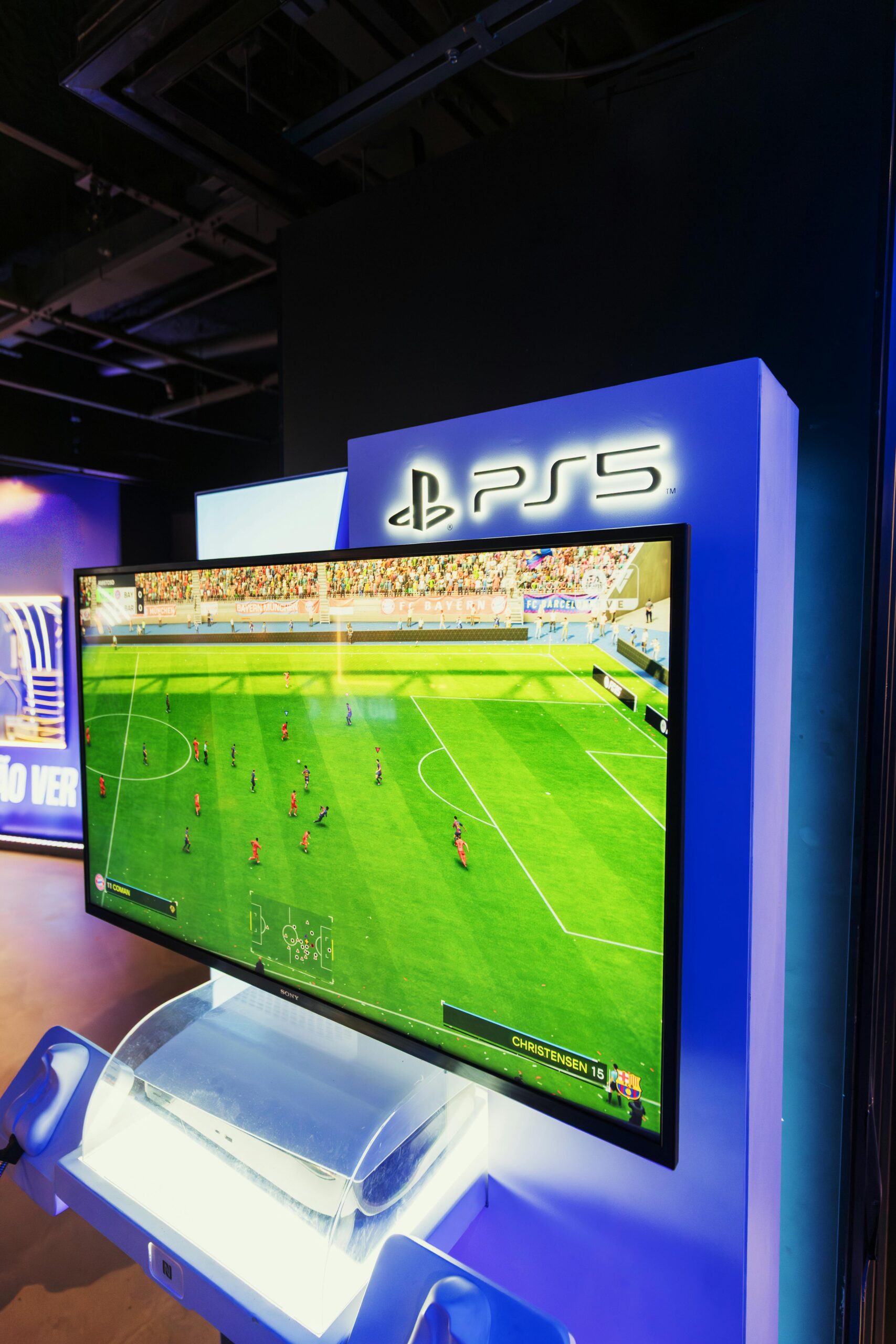 PS5 gaming console showcasing a soccer video game in a retail store setting.